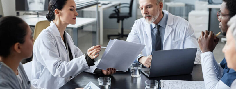 Doctors gathering around discussing.